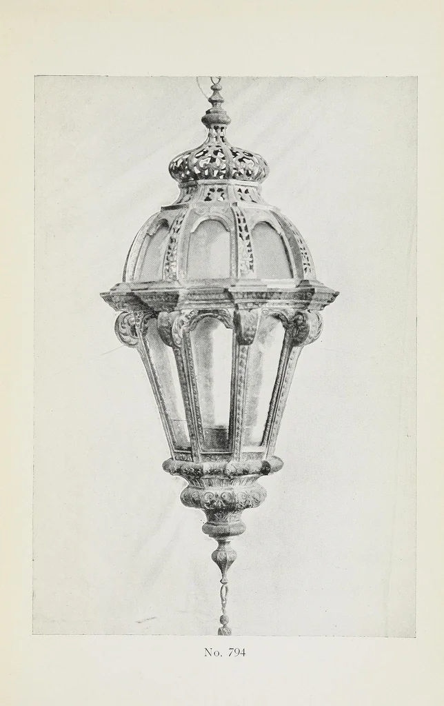 An illustration from Catalogue of the highly interesting and valuable collection of authentic Spanish antiques formed by Señor Luis Ruiz... : silver cathedral lanterns of the XVII century, the very rare carpets of the XVI & XVII century, the primitive paintings with their Gothic frames, also the wood and stone carvings, the Barguenos, cabinets, chests and chairs, the iron work and the old laces and fabrics, 1921, leaf 67