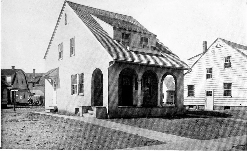 An illustration from The housing book; containing photographic reproductions, with floor plans of workingmen's homes. One and two family houses of frame, brick, stucco and concrete construction; also four, six and nine family apartments. Showing single houses, groups and developments that have been built in various parts of the United States, 1919, leaf 26