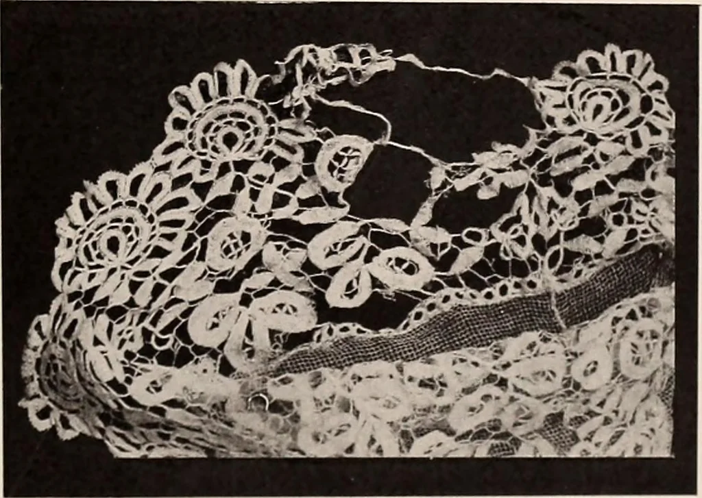 An illustration from A history of hand-made lace : dealing with the origin of lace, the growth of the great lace centres, the mode of manufacture, the methods of distinguishing and the care of various kinds of lace, 1900, leaf 124