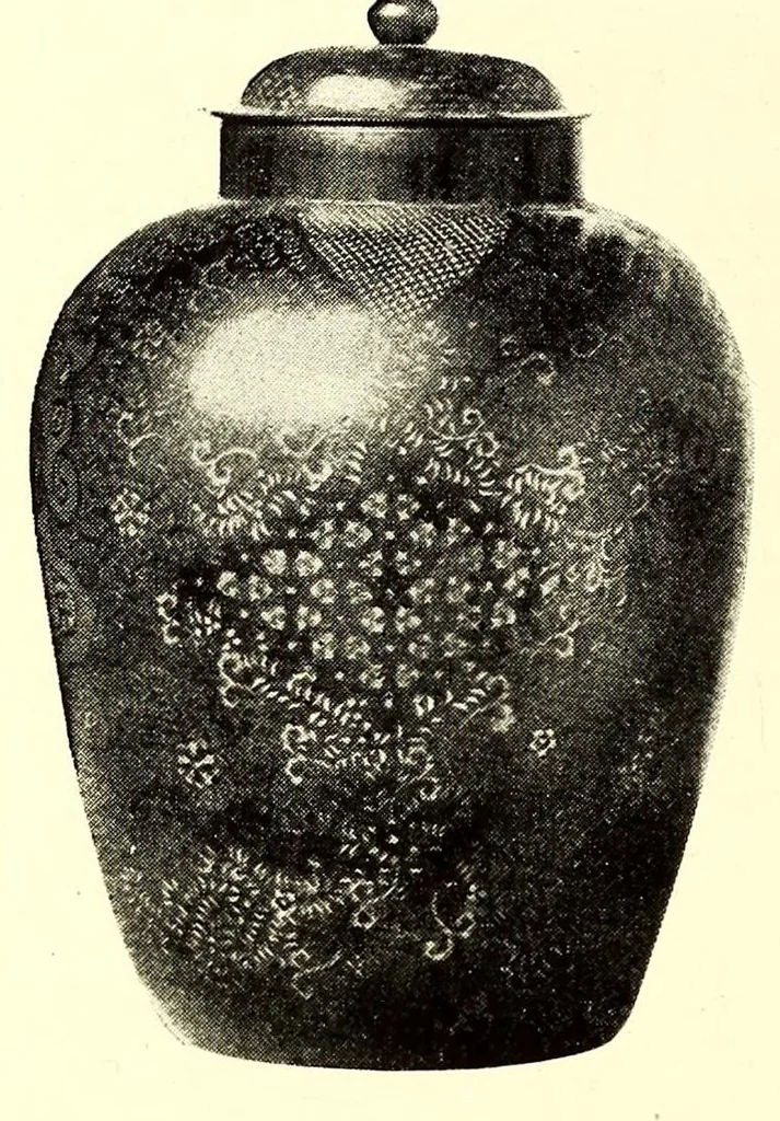 An illustration from Illustrated Catalogue of the Noteworthy Collection of Cloisonne and Other Enamels, Old Japanese Bronzes, Sword Guards, Knife Handles, Swords, Lacquers and Fine Old Brocades : belonging to Dr. Alfred Owre of Minneapolis, 1917, leaf 150