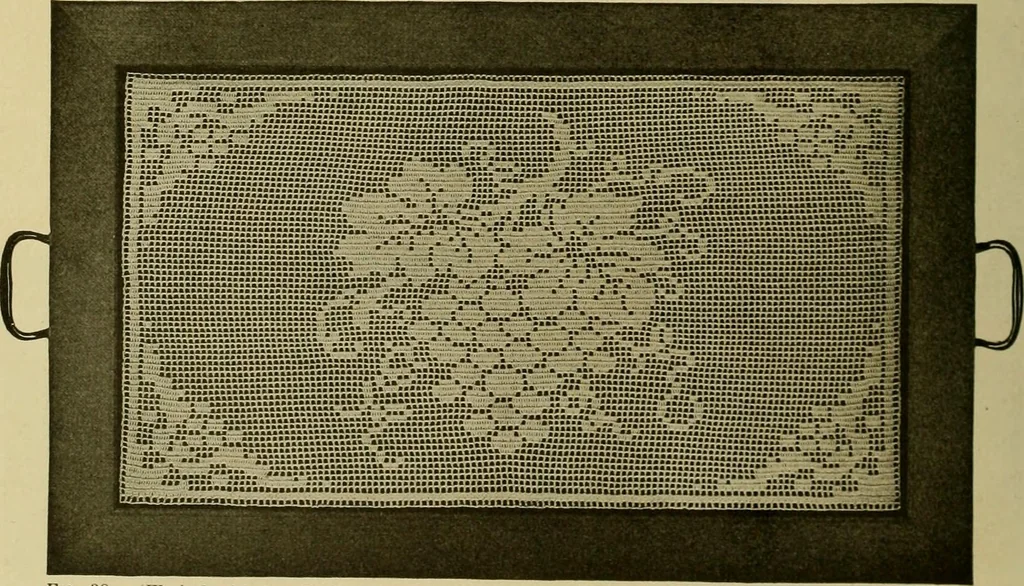 An illustration from The Priscilla filet crochet book, no. 2 ; a collection of beautiful designs in filet crochet, introducing filet crochet brodé, embroidery on crochet and cameo crochet, 1914, leaf 21