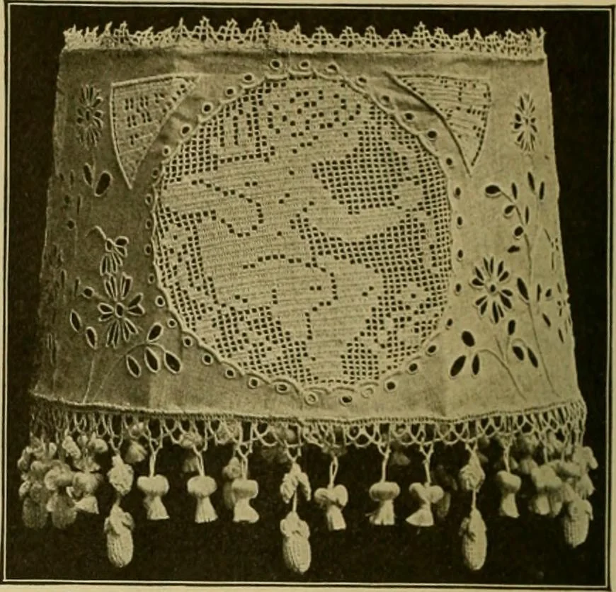An illustration from The Priscilla filet crochet book, no. 2 ; a collection of beautiful designs in filet crochet, introducing filet crochet brodé, embroidery on crochet and cameo crochet, 1914, leaf 23