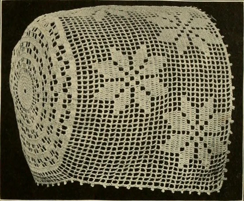 An illustration from The Priscilla filet crochet book; a collection of beautiful designs in filet crochet, equally adapted to cross-stitch, beads and canvas, with working directions, 1911, leaf 20