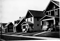 An illustration from The housing book; containing photographic reproductions, with floor plans of workingmen's homes. One and two family houses of frame, brick, stucco and concrete construction; also four, six and nine family apartments. Showing single houses, groups and developments that have been built in various parts of the United States (1919)
