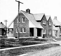 An illustration from The housing book; containing photographic reproductions, with floor plans of workingmen's homes. One and two family houses of frame, brick, stucco and concrete construction; also four, six and nine family apartments. Showing single houses, groups and developments that have been built in various parts of the United States (1919)