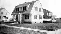 An illustration from The housing book; containing photographic reproductions, with floor plans of workingmen's homes. One and two family houses of frame, brick, stucco and concrete construction; also four, six and nine family apartments. Showing single houses, groups and developments that have been built in various parts of the United States (1919)
