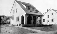 An illustration from The housing book; containing photographic reproductions, with floor plans of workingmen's homes. One and two family houses of frame, brick, stucco and concrete construction; also four, six and nine family apartments. Showing single houses, groups and developments that have been built in various parts of the United States (1919)