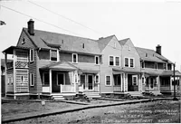 An illustration from The housing book; containing photographic reproductions, with floor plans of workingmen's homes. One and two family houses of frame, brick, stucco and concrete construction; also four, six and nine family apartments. Showing single houses, groups and developments that have been built in various parts of the United States (1919)
