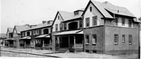 An illustration from The housing book; containing photographic reproductions, with floor plans of workingmen's homes. One and two family houses of frame, brick, stucco and concrete construction; also four, six and nine family apartments. Showing single houses, groups and developments that have been built in various parts of the United States (1919)