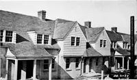 An illustration from The housing book; containing photographic reproductions, with floor plans of workingmen's homes. One and two family houses of frame, brick, stucco and concrete construction; also four, six and nine family apartments. Showing single houses, groups and developments that have been built in various parts of the United States (1919)