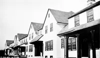 An illustration from The housing book; containing photographic reproductions, with floor plans of workingmen's homes. One and two family houses of frame, brick, stucco and concrete construction; also four, six and nine family apartments. Showing single houses, groups and developments that have been built in various parts of the United States (1919)