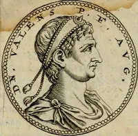 An illustration from De vita et moribus imperatorum Romanorum: excerpta ex libris Sexti Aurelii Victoris, à Caesare Augusto usque ad Theodosium imperatorem. Andreas Schottus compositis tribus M.SS. cum Vett. vulgatis emendabat; scholiis & veris iconibus ex antiquis numismatis delineatis illustrabat. Quibus accesserunt & Eliae Vineti notae (1669)