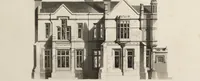 An illustration from Domestic architecture, being a series of designs for mansions, villas, rectory houses, parsonage houses, bailiffs' lodge, gardener's lodge, game-keeper's lodge, park gate lodges, etc. in the Grecian, Italian, and old English styles of architecture. With observations on the appropriate choice of site; the whole designed with strict reference to the practicability of erection, and with due attention to the important consideration of uniting elegance, convenience and domestic comfort with economy ... With accurate estimates appended to each design (1833)