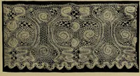 An illustration from A history of hand-made lace : Dealing with the origin of lace, the growth of the great lace centres, the mode of manufacture, the methods of distinguishing and the care of various kinds of lace ... (1900)