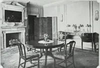 An illustration from House & garden's book of interiors, containing over three hundred illustrations of living rooms, dining rooms, libraries, halls, bedrooms, porches, breakfast rooms, nurseries, kitchens, bathrooms and the use of decorative accessories and curtains, together with practical suggestions for the furnishing and decorating of each type of room in the house (1920)
