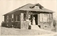 An illustration from The plan book of American dwellings : being a compilation of original home designs, showing actual photographic exteriors and floor plans of moderately priced bungalows, cottages, residences (1914)