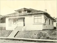 An illustration from The plan book of American dwellings : being a compilation of original home designs, showing actual photographic exteriors and floor plans of moderately priced bungalows, cottages, residences (1914)